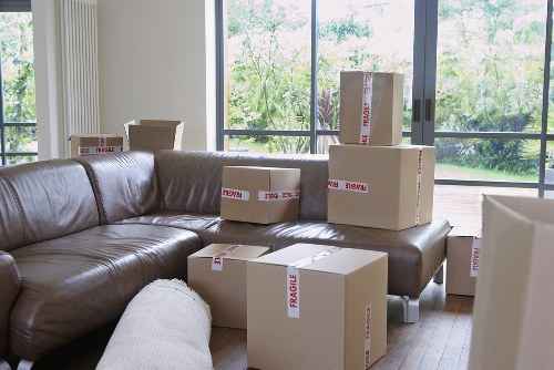 Professional movers loading boxes into a van in Coulsdon